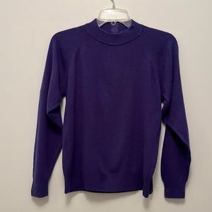 Lavender long sleeves sweater with zipper in back. See photo.